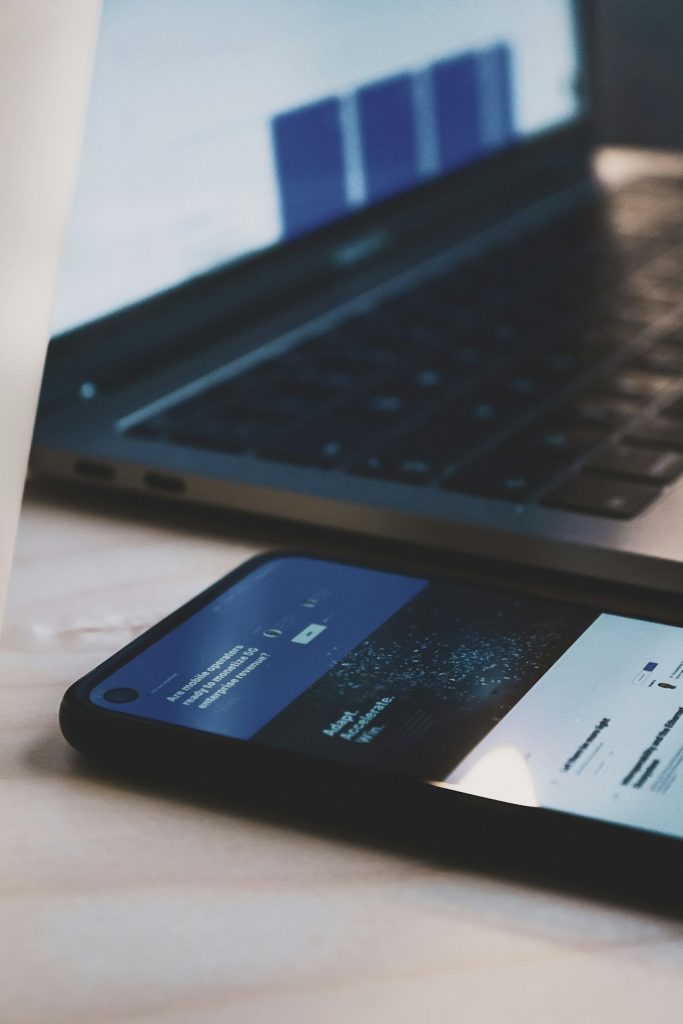 black-android-smartphone-beside-black-laptop-computer-xlz9ep4hjtq